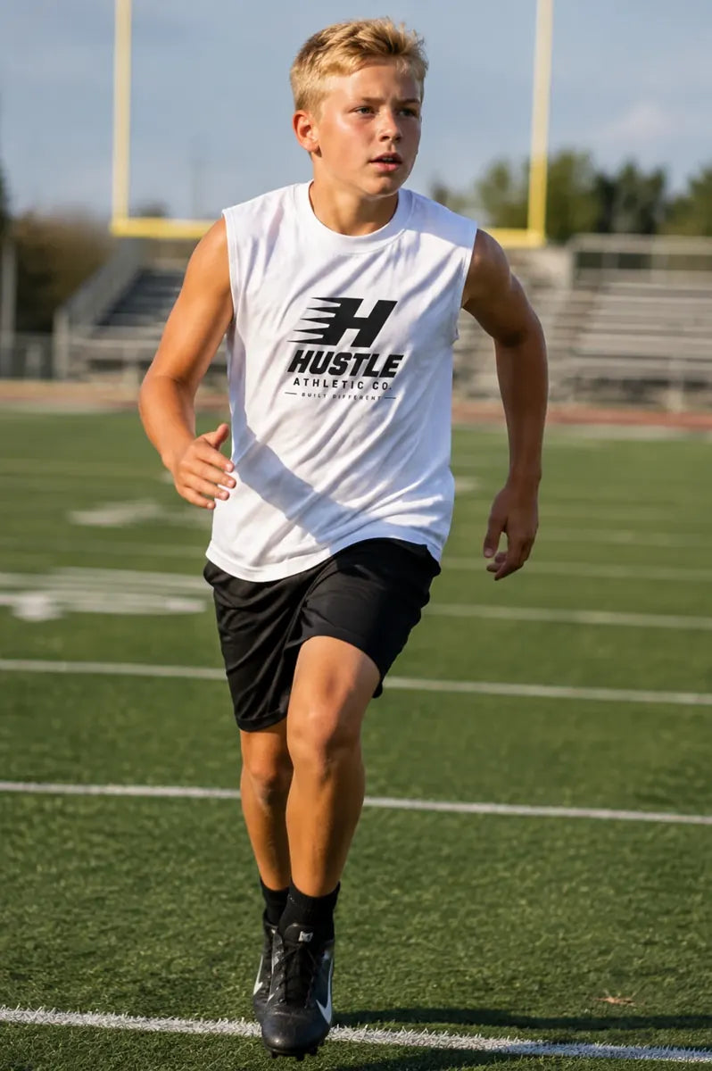 Youth athlete wearing a Hustle tank on the football field