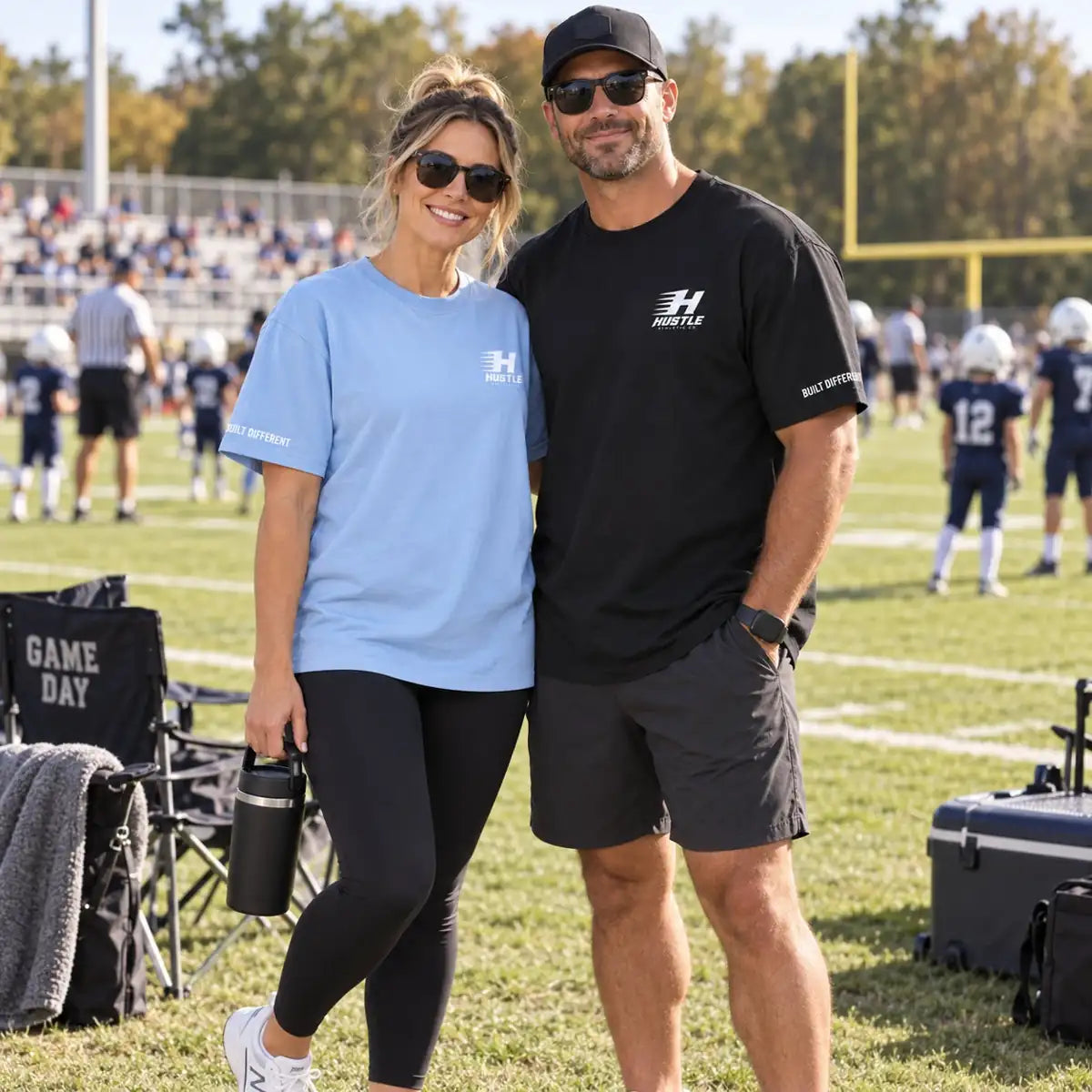 Parents wearing Hustle logo tees on the football sideline